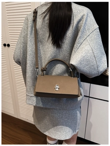 Brown lychee-texture leather handbag with silver twist lock and adjustable strap