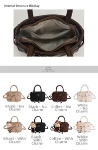 Detail view of small square handbag interior with central zipper and color variants