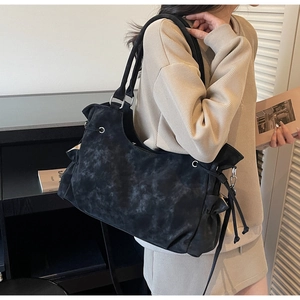 Detail of black large capacity tote bag with marble texture and side drawstring for daily use