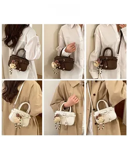Detail showing mini crossbody bags in coffee and beige with plush bear charms