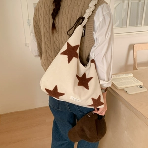 Detailed view of canvas star tote bag featuring velvet texture and brand label detail