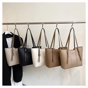 Selection of large leather tote bags in five colors hanging for professional commuting