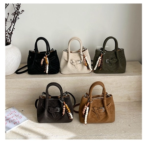 Group shot of five chevron quilted suede bucket bags with ethnic beaded tassels