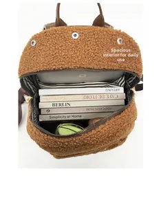 Spacious interior of brown faux shearling backpack showing room for books and laptop