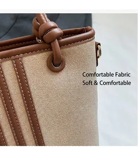 Detail of woven fabric bucket bag with brown leather trim and knotted handle craftsmanship