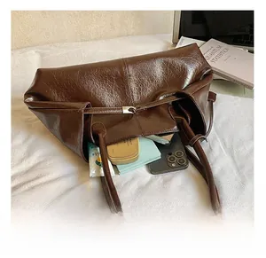 Detail view of large dark brown tote bag showing interior storage capacity and wax leather