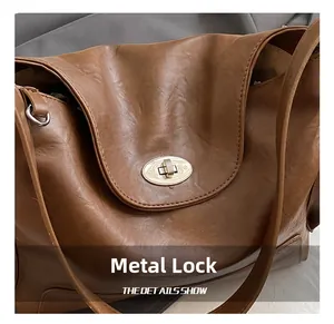 Detail of vintage brown tote bag featuring a brushed gold oval twist lock closure