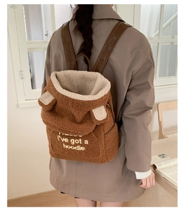 Brown teddy fleece backpack with bear ears detail and white embroidered text on flap
