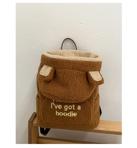 Detailed texture of brown teddy fleece backpack with cute ears and hoodie embroidery
