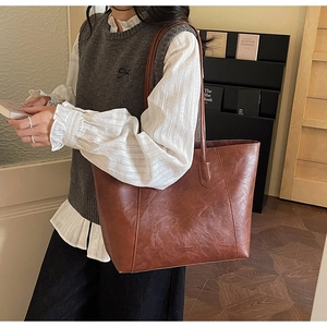 Detailed view of large vintage brown tote bag in oily faux leather for work
