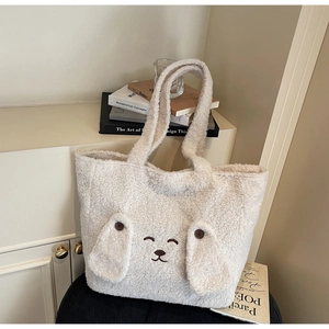 Close-up of white plush tote bag featuring cute embroidered animal face and floppy ears