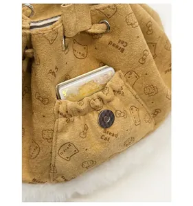 Detail of bread cat patterned drawstring bucket bag with front pocket and magnetic clasp