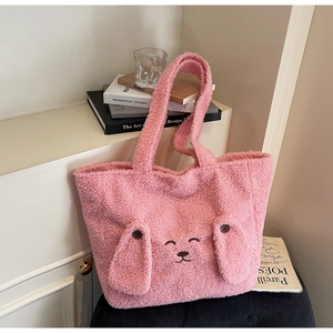 Detail of pink plush tote bag showing soft fuzzy texture and cute animal embroidery