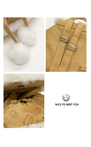 Detail of plush camel backpack showing white faux fur trim and cute silver hardware