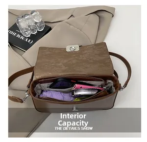 Spacious interior of brown leather shoulder bag with zipper pocket and daily essentials