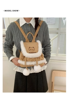 Detail showing plush trim and cute cat embroidery on a khaki corduroy backpack
