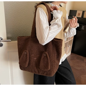 Detail of cute plush teddy brown tote bag featuring 3D ears and cartoon embroidery detail