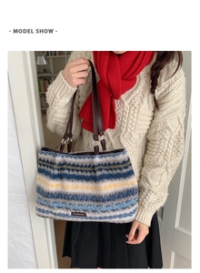 Model show of striped plush tote bag with brown leather straps and soft wool texture