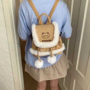 Detail of the bucket backpack featuring suede material, plush trim and cat embroidery