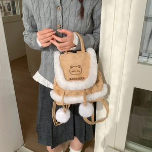 Detail of camel suede bucket bag featuring cute cat embroidery and white faux fur trim