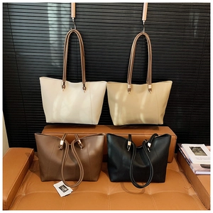 Detail of four versatile leather tote bags in white, beige, brown, and black with thin straps