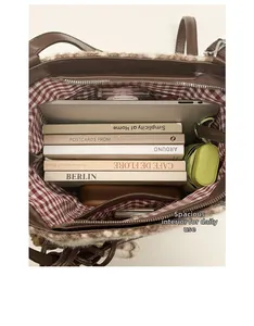 Large capacity brown plush tote bag showing internal storage for laptop and books