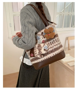 Detail of plush拼接 tote bag with faux fur texture, bear charm and leather strap