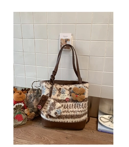 Close-up of Nordic jacquard plush tote bag with leather base and a cute bear charm