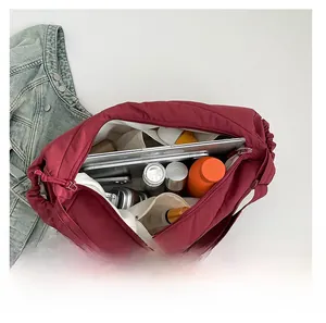 Top-down detail showing the spacious interior and compartments of this burgundy tote bag