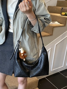 Fashionable black woven hobo tote bag for women with cute plush charm pendant