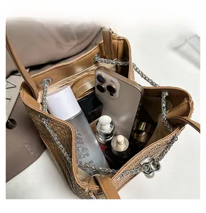 Interior view of brown bucket bag showing large capacity for phone and cosmetics