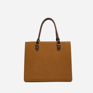 Detailed view of camel faux suede tote bag with dark brown handles and gold hardware