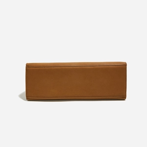 Detail view of the rectangular brown leather bag bottom showing neat stitching and smooth texture
