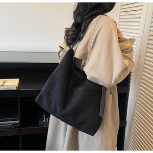Macro detail of high-capacity black faux suede tote bag with durable zipper closure