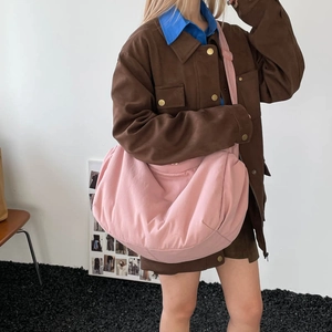 Pink large capacity crescent crossbody bag shown on a model in vintage aesthetic outfit