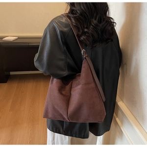 Close-up of vintage brown suede tote bag with side pocket and spacious interior