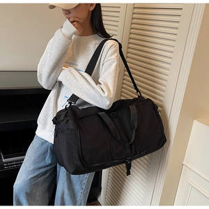 Detail of waterproof nylon gym bag with adjustable strap and large main compartment