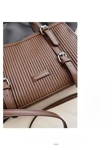 Close-up of pleated dark brown leather texture with adjustable silver metal buckle detail