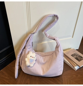 Detail of soft lavender hobo bag with quilted texture and cute white bunny charm