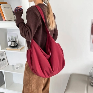 Spacious burgundy hobo bag shown cross-body, ideal for casual and daily travel