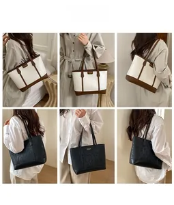 Détail du grand sac cabas en cuir beige et noir avec logo doré élégant et spacieux