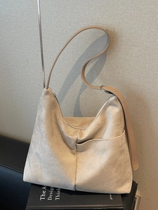 Minimalist beige suede tote bag with adjustable shoulder strap and large capacity