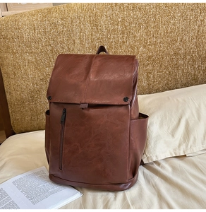 Detailed close-up of dark brown vintage faux leather backpack with refined texture