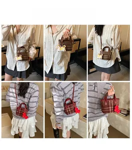 Detailed views of plaid patterned bucket bag with leather handles and cute plush charm