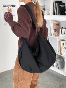 Large black nylon crossbody crescent bag with wide adjustable strap for daily commute