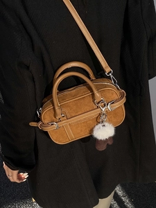 Vintage brown suede bowling bag for women with plush charm and crossbody strap