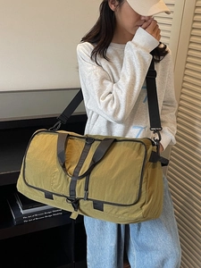 Large mustard yellow folding travel bag with adjustable strap for gym and sports