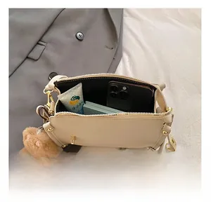 Top view of beige leather bag interior showing capacity for daily essentials