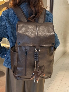 Classic dark brown PU leather backpack for commuting featuring a flap cover and cute charms
