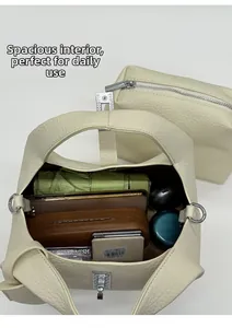 Top view of cream bucket bag interior showing capacity for umbrella, phone, and cosmetics